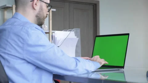 Over the Shoulder Shot of Mans Hands Typing on a Laptop with Green Screen Stock Footage 146319907