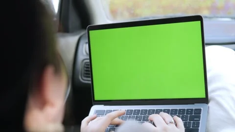 Over-the-shoulder shot of person using laptop in vehicle Stock Footage 343585977