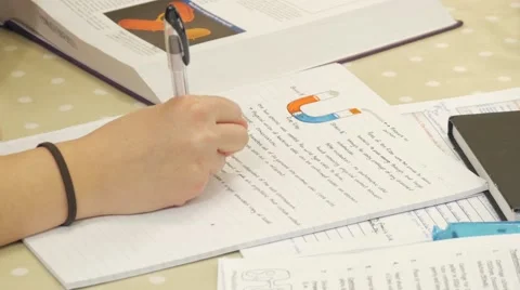 A over the shoulder shot of student doing her homework/essay for university. Stock Footage 47015126