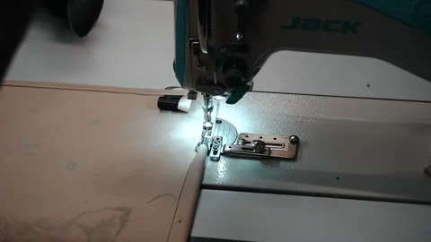 Over the shoulder shot of worker sewing fabric Stock Footage 135160651