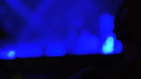 An over the shoulder slow focus pull shot of a silhouette of black Dj Stock Footage 129934035