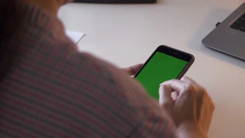 Over the shoulder, unrecognizable person using smartphone. Stock Footage 173743047