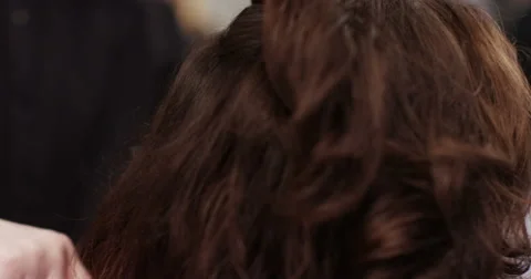 Over shoulder view of of barber preparing client in barber shop. Shot on RED Epi Stock Footage 59740689