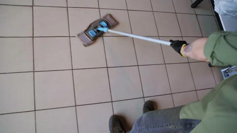 Over-the-Shoulder View of Barista Mopping Floor in Cafeteria Stock-Footage 307561579