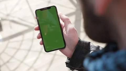 Over shoulder view of bearded unrecognizable man actively using his expensive Stock-Footage 104904443