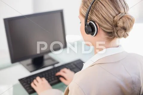 Over shoulder view of blonde call centre agent working Stock Photos