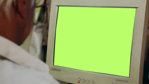 Over The Shoulder View Of Blurred Man Looking At Vintage Monitor Green Screen 4K Stock Footage 337646527