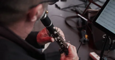 Over-the-shoulder view of clarinetist playing, showing fingerings and keys. Stock Footage 313998846