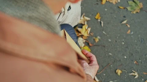 An over the shoulder view of an elderly person opening a handwritten letter in a Stock Footage 100629042