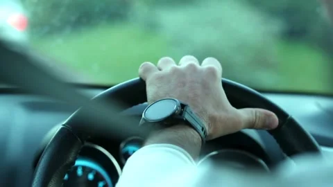 Over shoulder view of man driving car. Close up shot of male hands on steering Stock-Footage 336265179