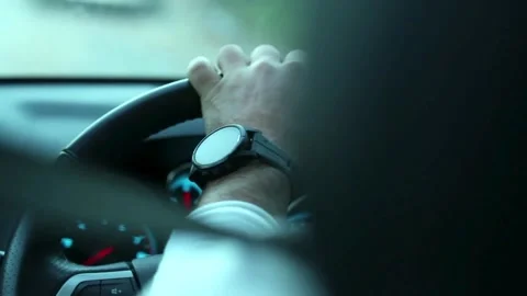 Over shoulder view of man driving car. Close up shot of male hands on steering Stock-Footage 336265440