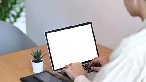 Over shoulder view of man freelancer working with laptop computer. Stock Photos