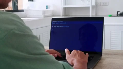 Over the shoulder view of man programmer working at home writing programming Stock-Footage 197994323