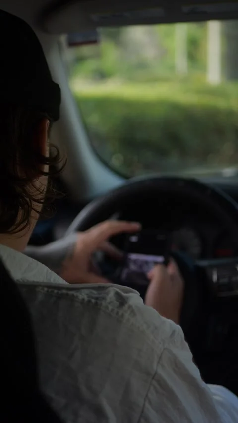 Over-the-shoulder view of man sitting in parked car... Stock Footage 324632462