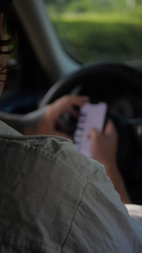 Over-the-shoulder view of man sitting in parked car... Stock Footage 324632468