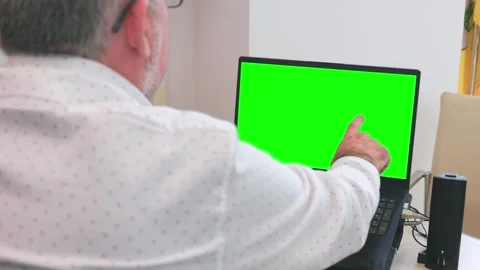 Over the shoulder view of a man working on a laptop with replaceable screen Stock Footage 323267019