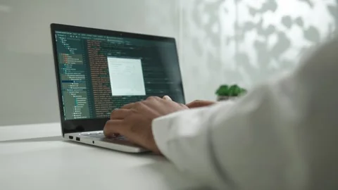 Over the shoulder view of qualified professional male programmer coding on Stock Footage 277433255