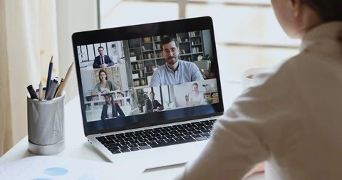 Over shoulder view of remote worker participating group virtual meeting Stock Footage
