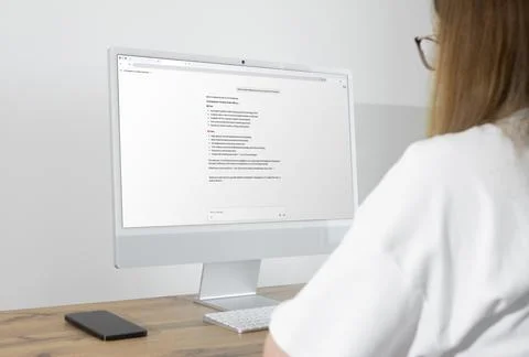 Over shoulder view of woman using AI chatbot assistant on computer screen f.. Stock Photos