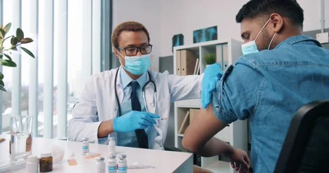 Over shoulder view of young African American handsome experienced man doctor in Stock Footage 147855870