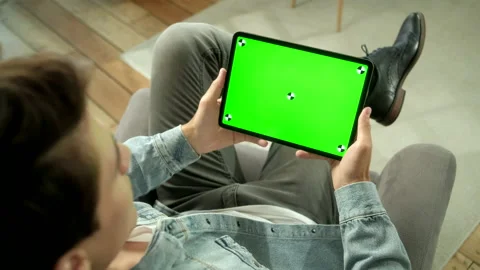 Over The Shoulder View Young Man at Home Sitting on a Chair Using With Green Stock Footage 133275614