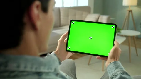 Over The Shoulder View Young Man at Home Sitting on a Chair Using with Green Stock Footage 133277327