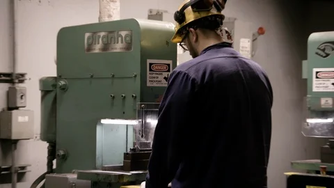 Over the shoulder Worker in hard hat at milling machine Stock Footage 89944617
