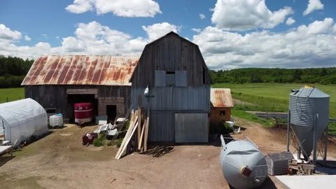 Over a small farm and into the field Stock Footage 158757485