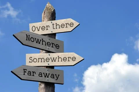 Over there, somewhere, nowhere, far away - wooden signpost with four arrows Foto stock