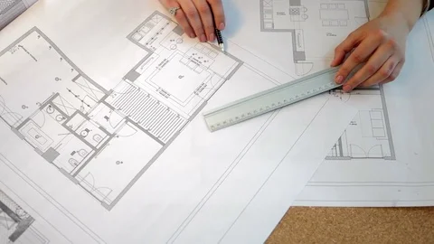 Over top view of architect working on blueprints plan. Blusiness woman with Stock Footage