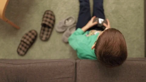 Over the top view of a little boy gaming at home Stock Footage 102416113