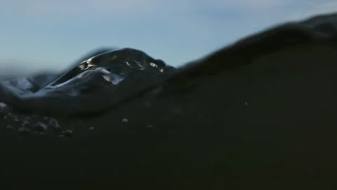 Over-under shot of something bobbing around at ocean surface Stock Footage 340382392