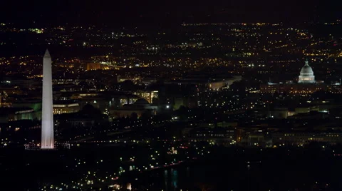 Over Washington DC cityscape at night, Washington Monument and Capitol in Vídeo Stock 59196033