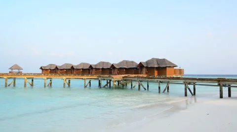 Over water bungalows with steps into amazing green lagoon Stock Footage 47195341