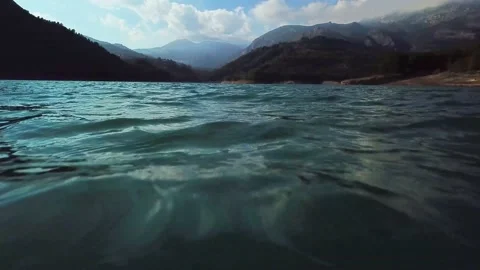 Over water with mountains in the background Stock Footage 239558125