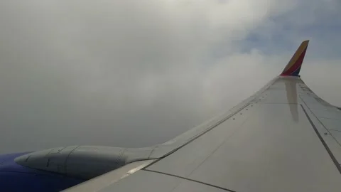 Over Wing view flying through clouds Video stock 153391407