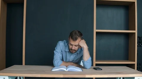 Over-worked, tired young man at home sleeping instead of working or studying Stock Footage 95920128