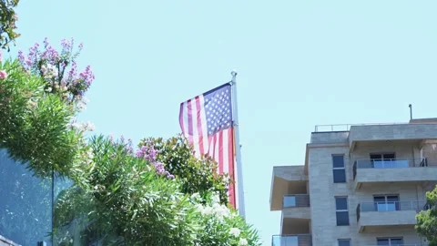The overall plan of the American flag develops in the wind against the Stock Footage 201326692