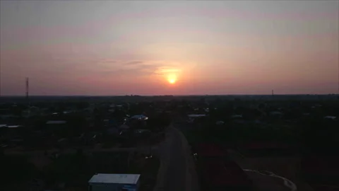 Overall sunset view of Ouesso with sun in distance, Congo Stockbeeldmateriaal 332000135