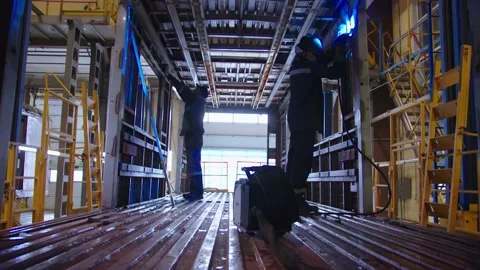 The overall view of factory labors in protective workwear and safety masks Stock Footage 202049107