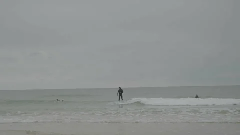 Overall view of surfer catching wave 動画素材 346282135