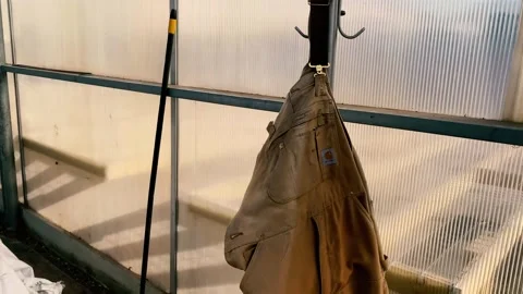Overalls Hanging in Greenhouse Stock Footage