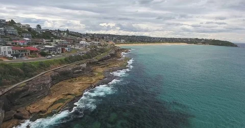 Overcast Aerial View ocean cliffs and beach in distance Stock Footage 70825449