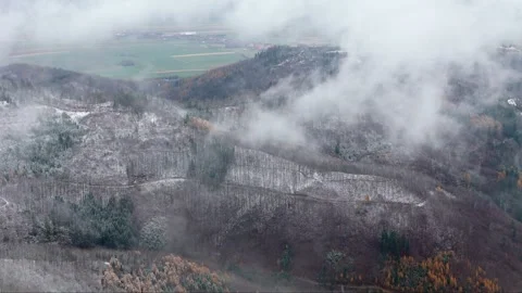 Overcast and windy conditions over snowy mountains, captured from the air, .. Stock Footage 258648230