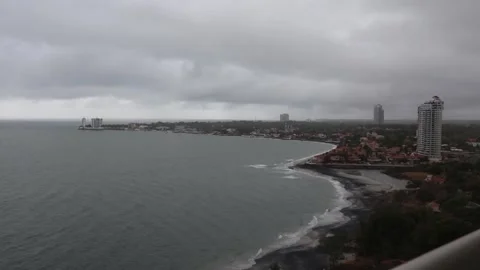 Overcast Beach View with Skyscraper and Ocean Waves Stock Footage 344977270
