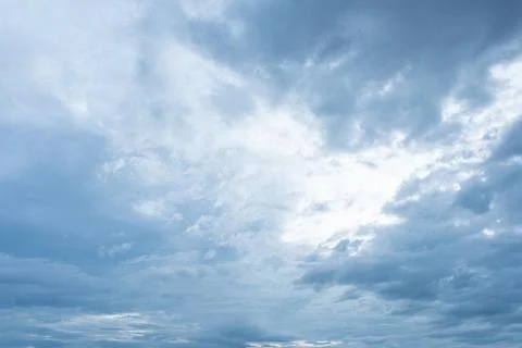 Overcast blue sky filled with dramatic thick gray and white storm clouds 스톡 사진