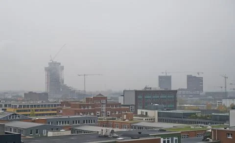 Overcast Cityscape with Construction Cranes Stock Photos