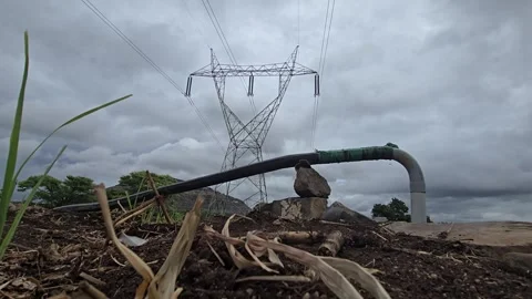Overcast clouds signal a rain delay. Under an electricity pylon's overhead lines Vídeo Stock 337482823