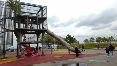 Overcast, cloudy day. modern children's playground in open air on promenade. Stock Footage 134595403