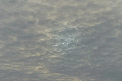 Overcast cloudy sky with a small, off-centered blue patch, a Stock Photos